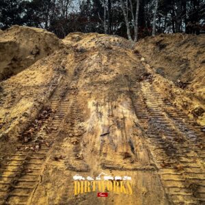 Large mound of dirt with yellow DirtWorks logo